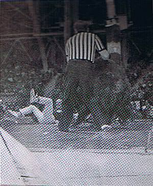 The bear knocks Greg out of the ring.