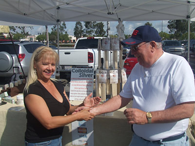 A surfer girl rubs Emu Oil on my arm
