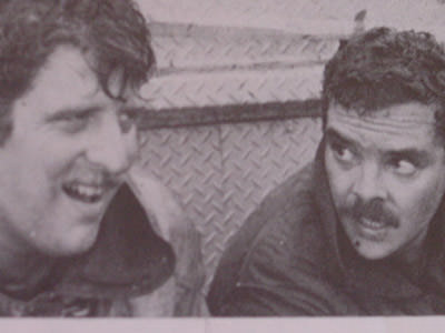 Bob Garrigan on the left rests with Pete Lopez after a harrowing fire